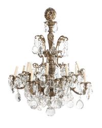 A Louis XV Style Gilt Bronze Sixteen-Light Chandelier, Height 37 inches x diameter 32 inches.