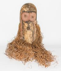 A Wabembe Wood and Grass Fiber Mask. Height 18 inches (without grass).