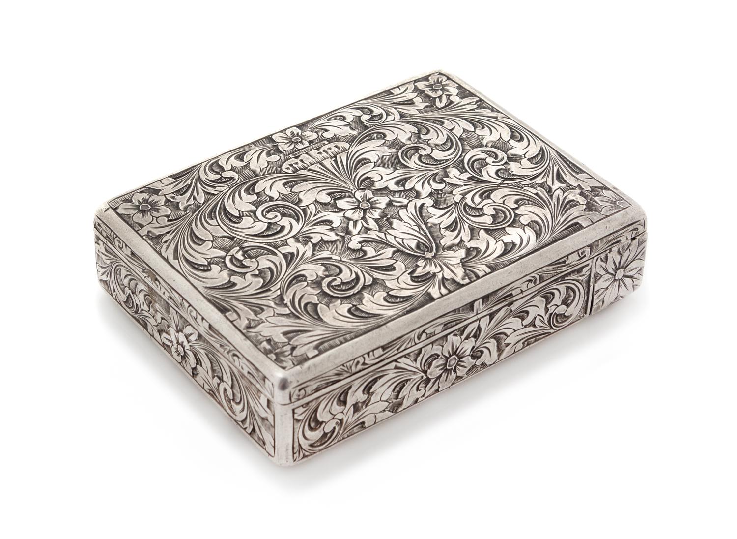 An Italian Silver Compact, First Half 20th Century, the case worked to show floral and foliate scroll decoration, opening to a mirrored