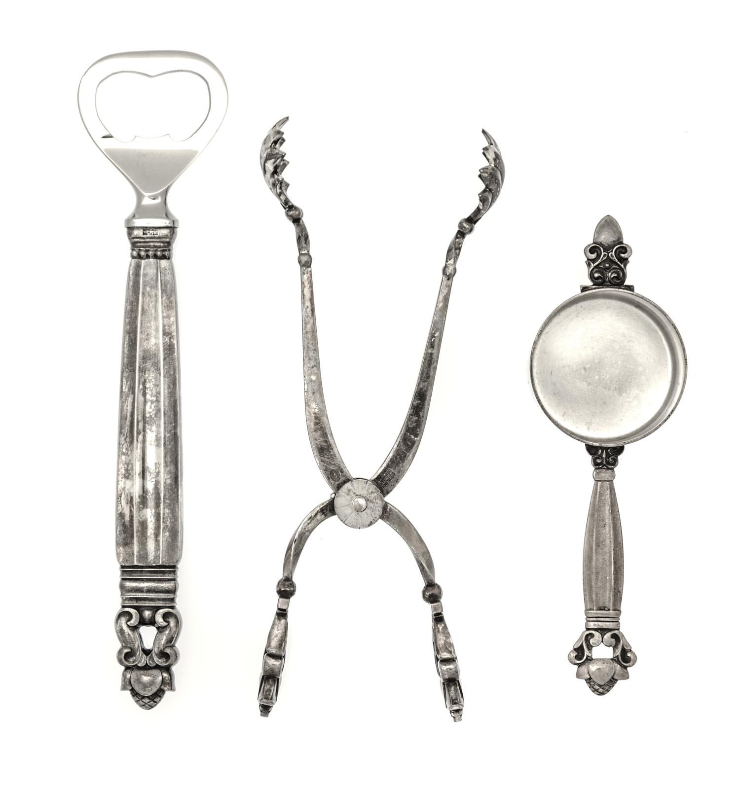 A Danish Silver Three-Piece Bar Set, Georg Jensen, Copenhagen, Acorn pattern, comprising a pair of tongs, a jigger and a bottle opener