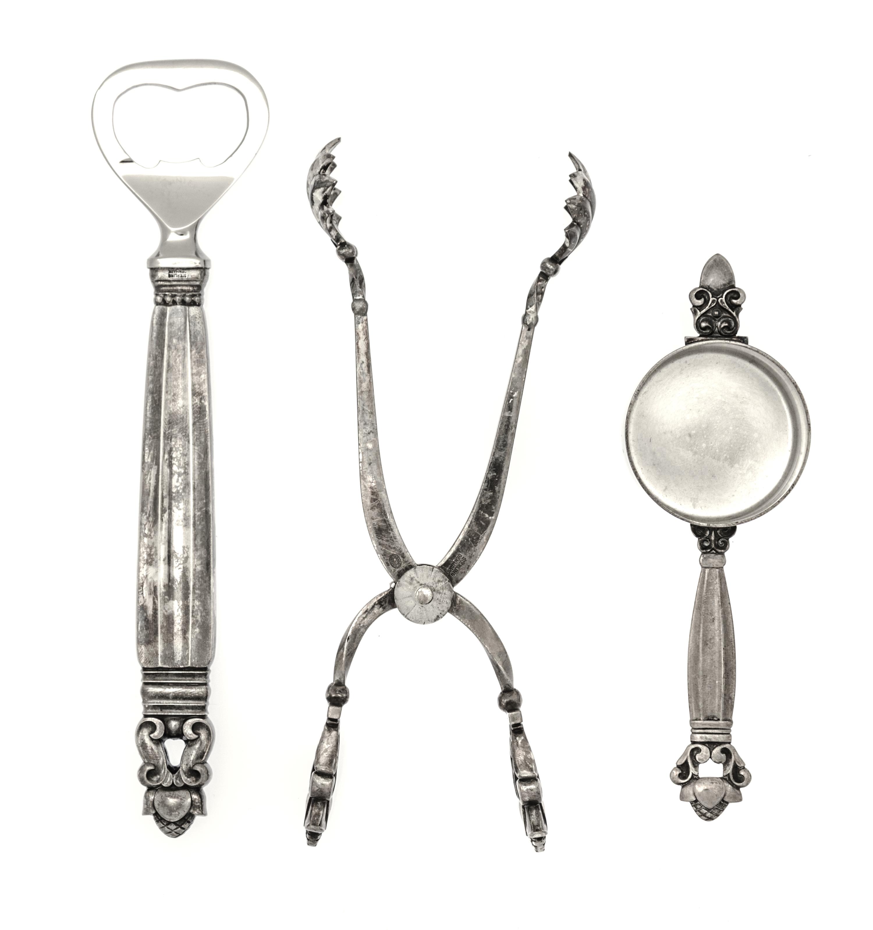 A Danish Silver Three-Piece Bar Set, Georg Jensen, Copenhagen, Acorn pattern, comprising a pair of tongs, a jigger and a bottle opener