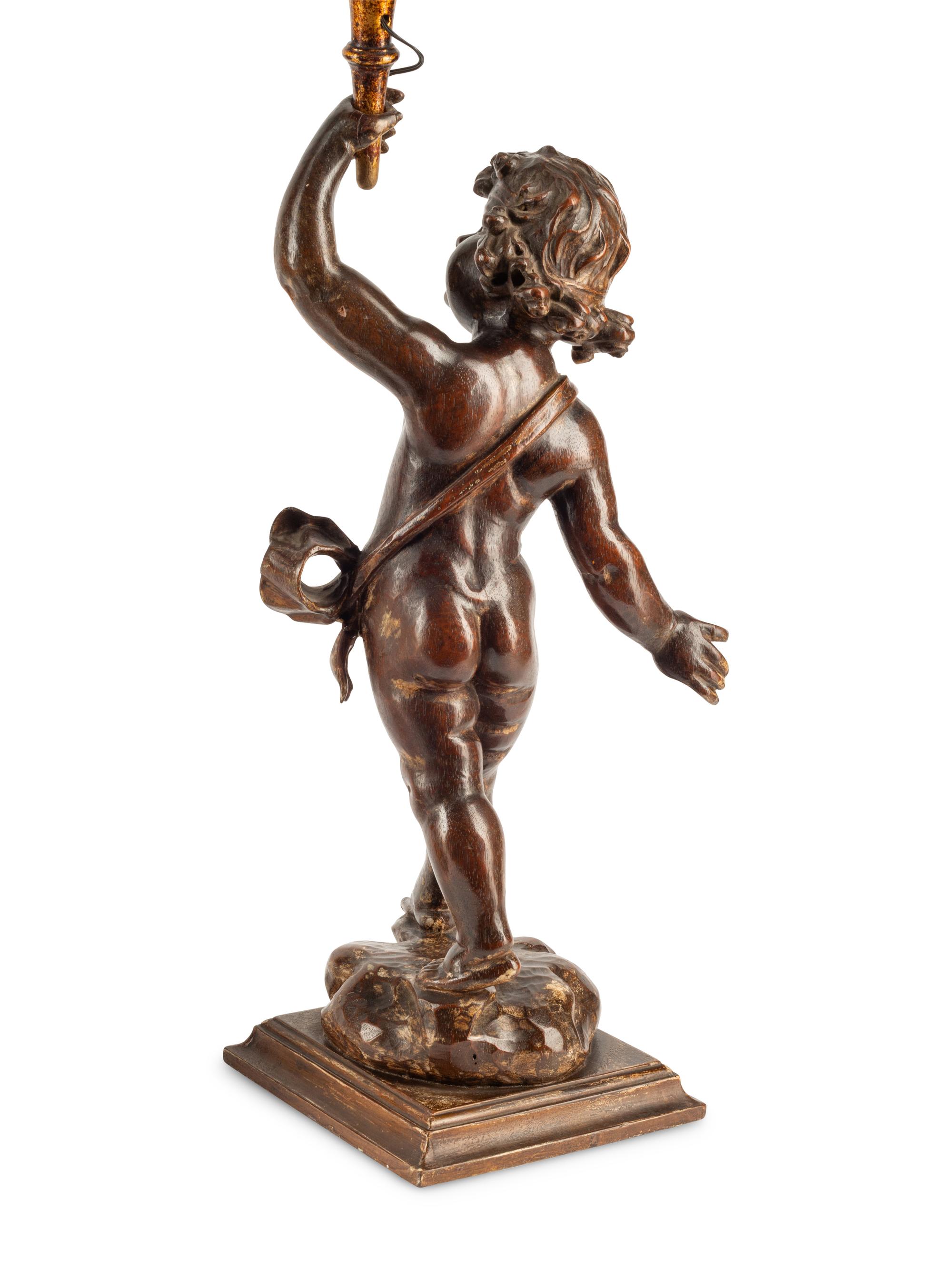 A Pair of Continental Carved Walnut Figures of Putti