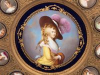 A Continental Porcelain Portrait and a Set of Twelve Similar Medallions in a Gilt Bronze Plaque