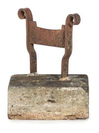 A Wrought Iron Boot Scrape with Stone Base