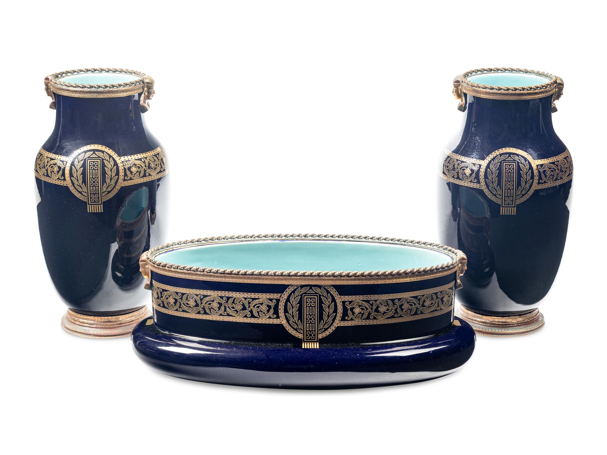 A Sarreguemines Cobalt Glazed Three-Piece Garniture with Egyptian Motif Mounts