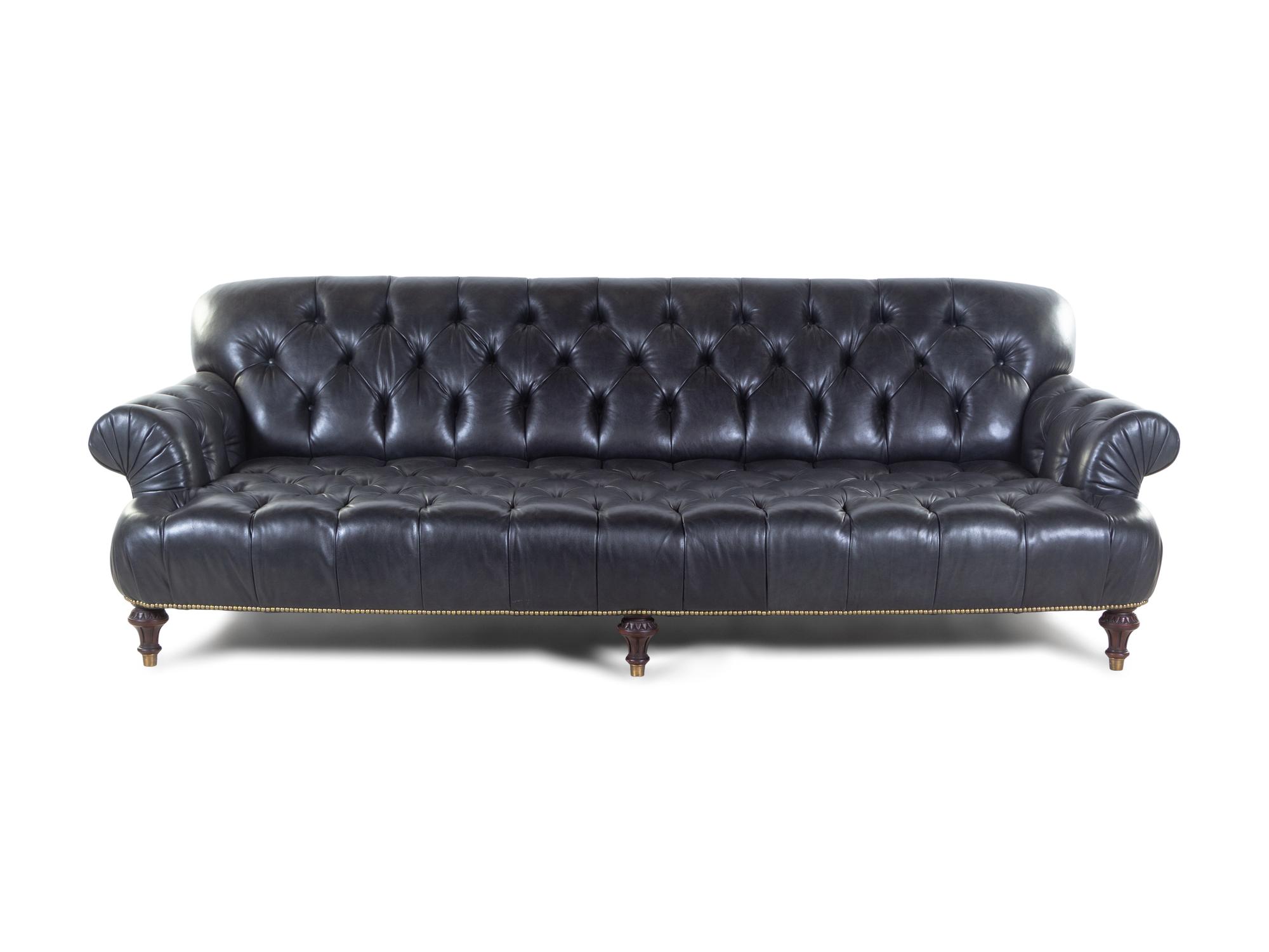 An Oversized Black Leather Upholstered Chesterfield Sofa