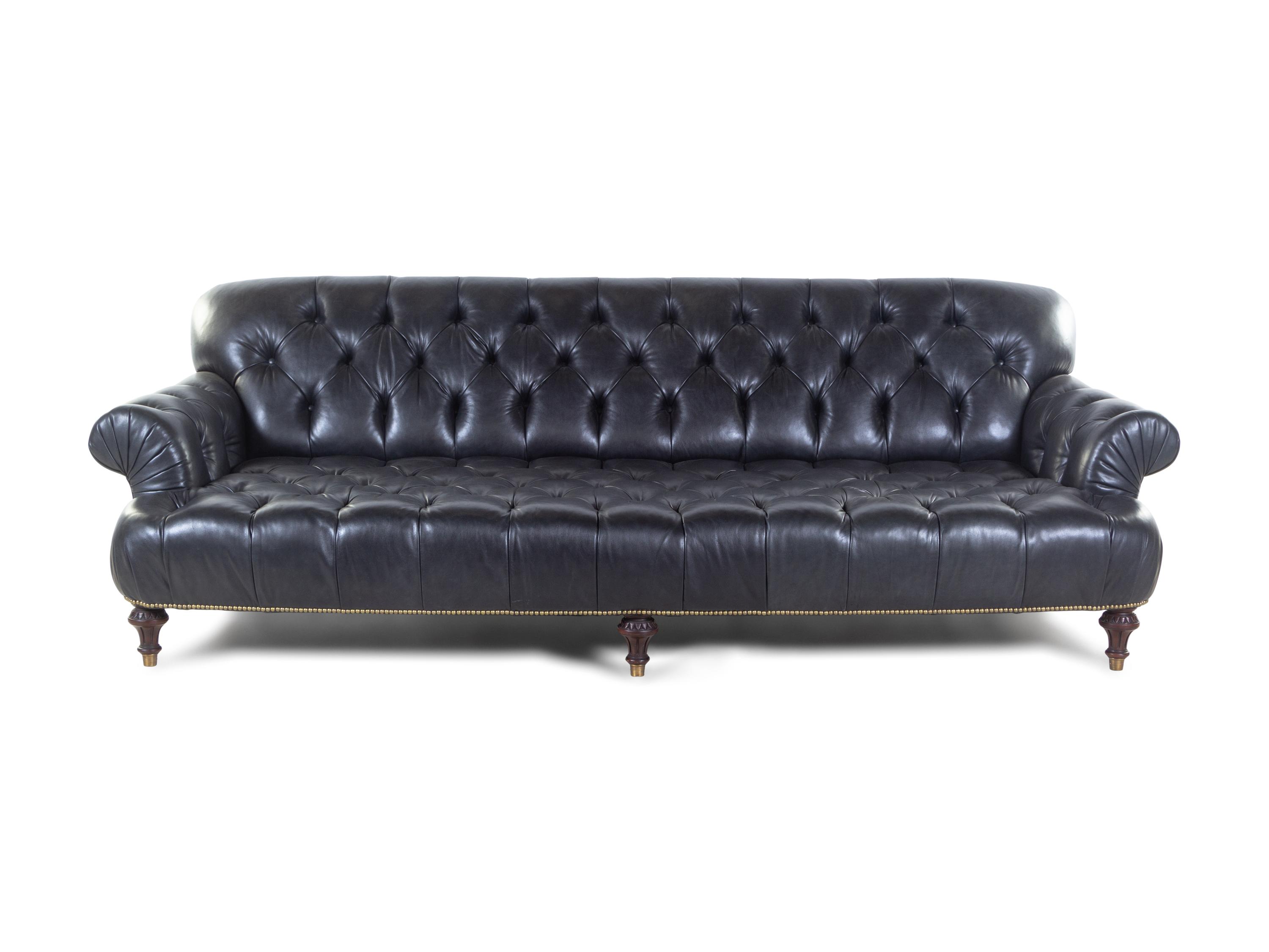 An Oversized Black Leather Upholstered Chesterfield Sofa