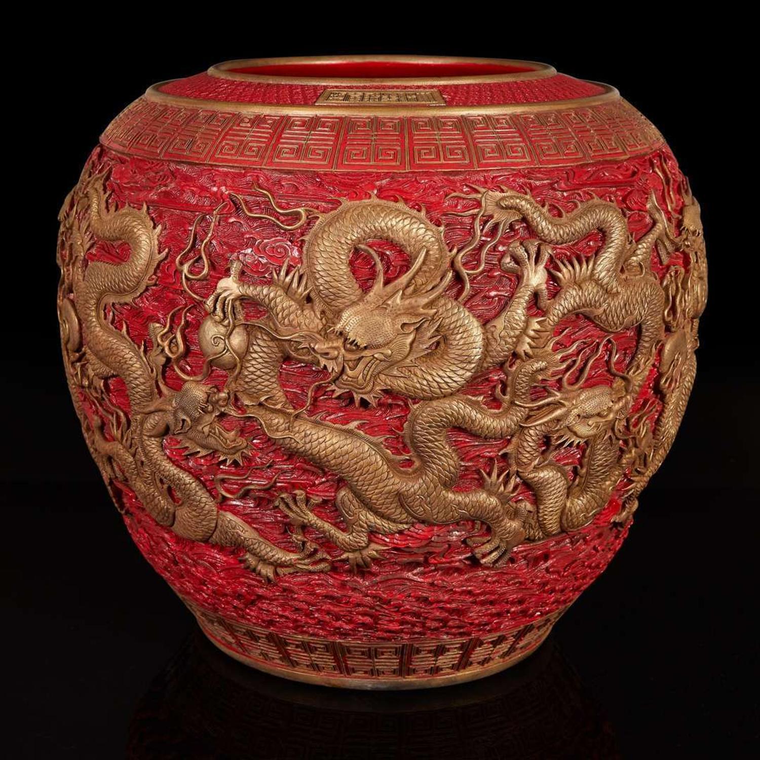 A massive Chinese faux cinnabar lacquer modeled porcelain "Dragons" jardinière 朱紅漆繪模印龍紋缸 Qianlong six character mark in relief to the neck ?????