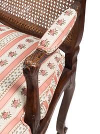 A Pair of Louis XV Provincial Walnut Caned Fauteuils