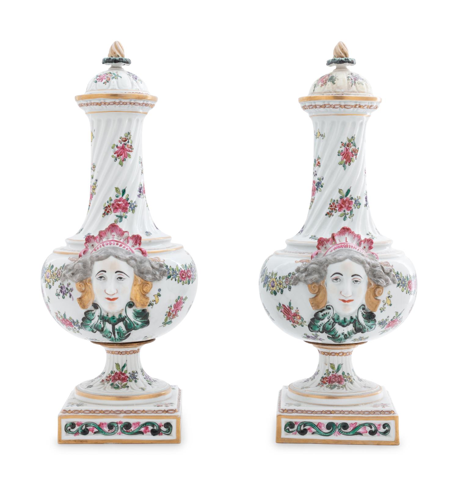 A Pair of Continental Painted and Parcel Gilt Porcelain Urns