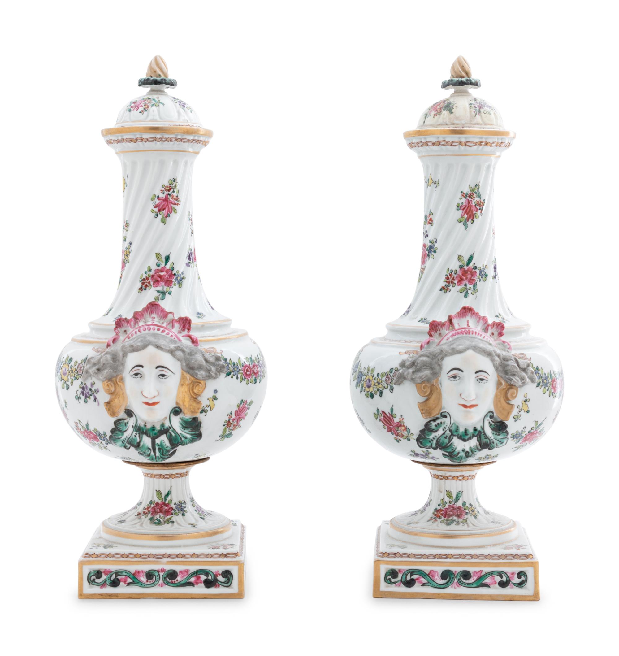A Pair of Continental Painted and Parcel Gilt Porcelain Urns