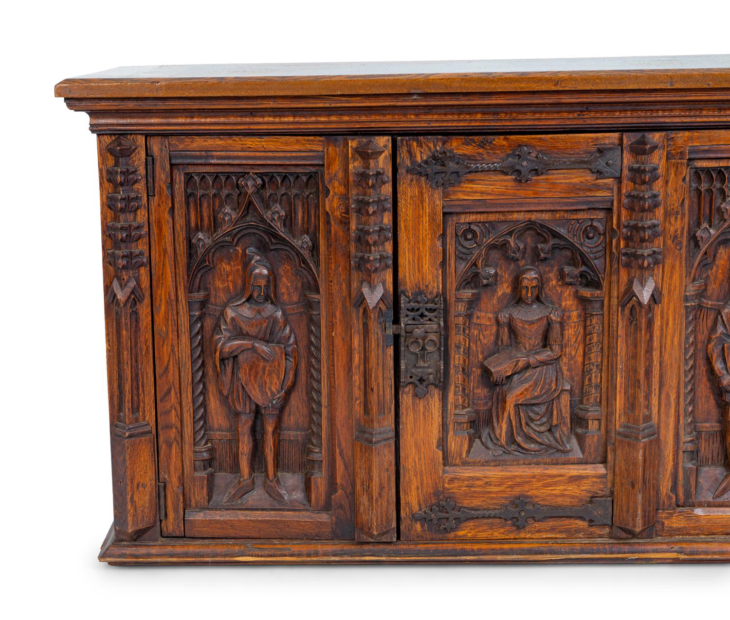 A Renaissance Revival Carved Oak Trunk with Iron Mounts — 19TH/20TH CENTURY