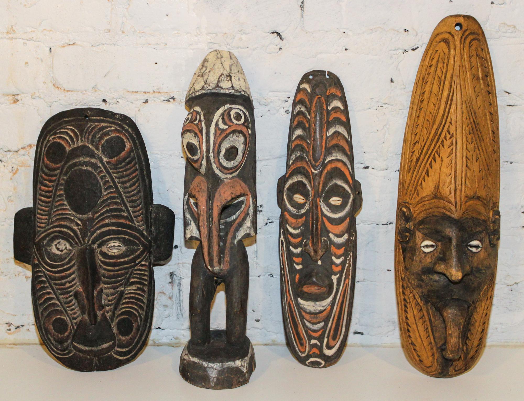 A Group of Sepik River Valley Articles, New Guinea Height of figure 15 1/2 inches.