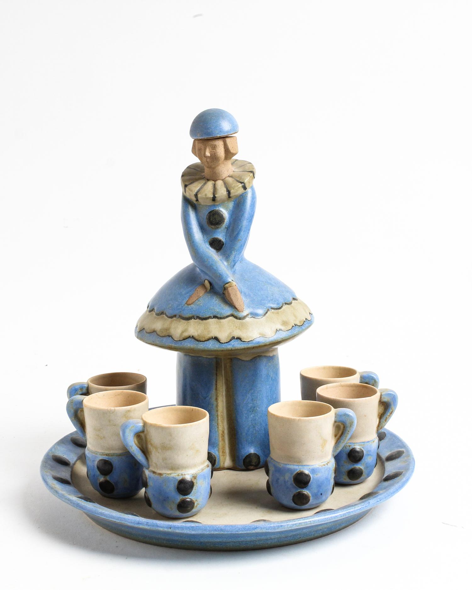 A Ceramic Figural Decanter and 6 Cups, with a Charger Height of decanter 10 inches — FIRST HALF 20TH CENTURY