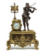 A French Gilt and Patinated Metal Figural Mantel Clock, Height 22 1/4 inches.