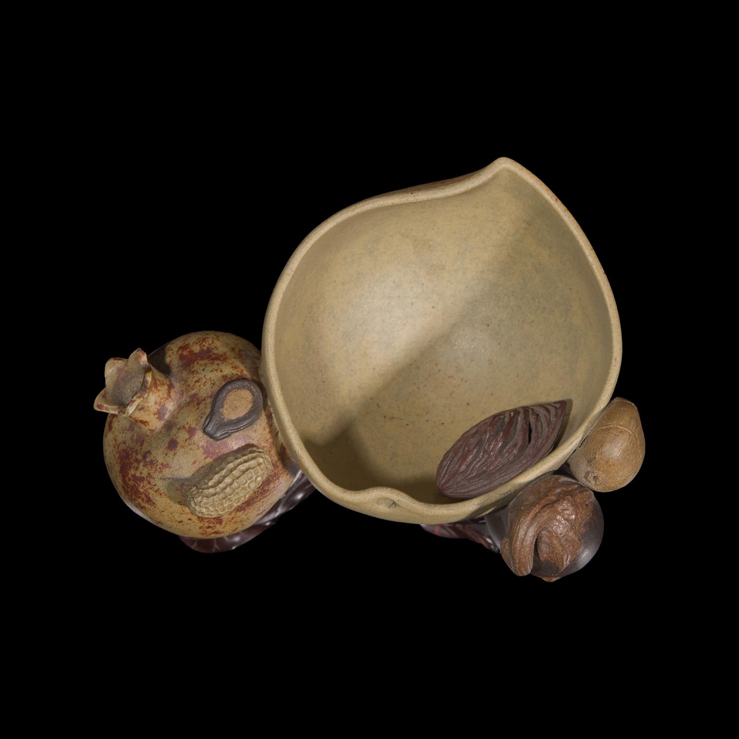 A Rare Chinese Yixing 'Peach and Pomegranate' Coupe Inscribed 'Chen Minyuan Zuo' and Carved Wood Stand 陳鳴遠款段泥紫砂桃榴杯