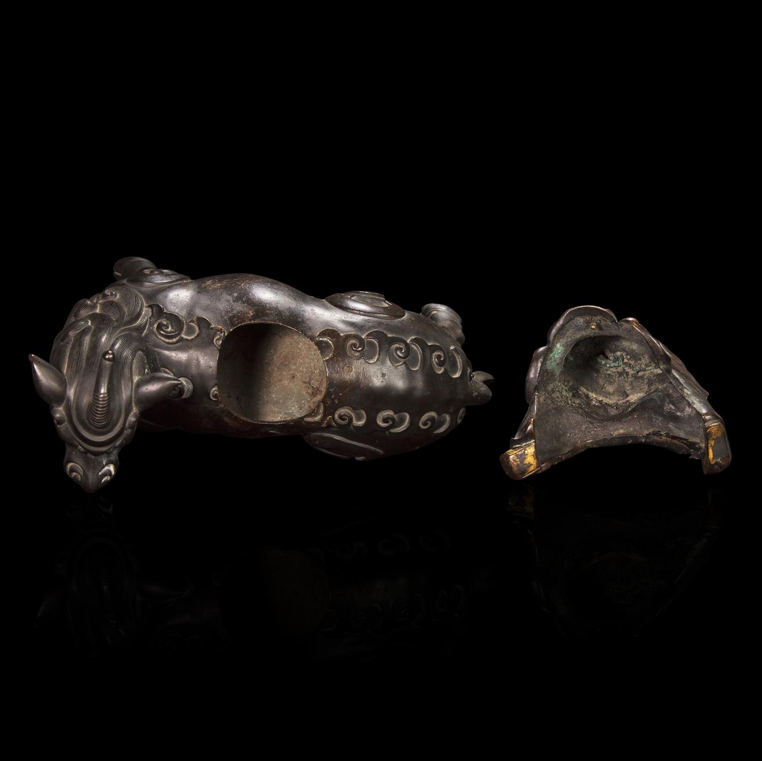 A Chinese Patinated and Parcel-gilt Bronze 'Qilin and Boy' Censer, 17th/18th Century 清早期 銅局部鎏金麒麟童子香薰