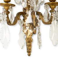 A Pair of Louis XVI Style Gilt Bronze and Cut Glass Three-Light Sconces