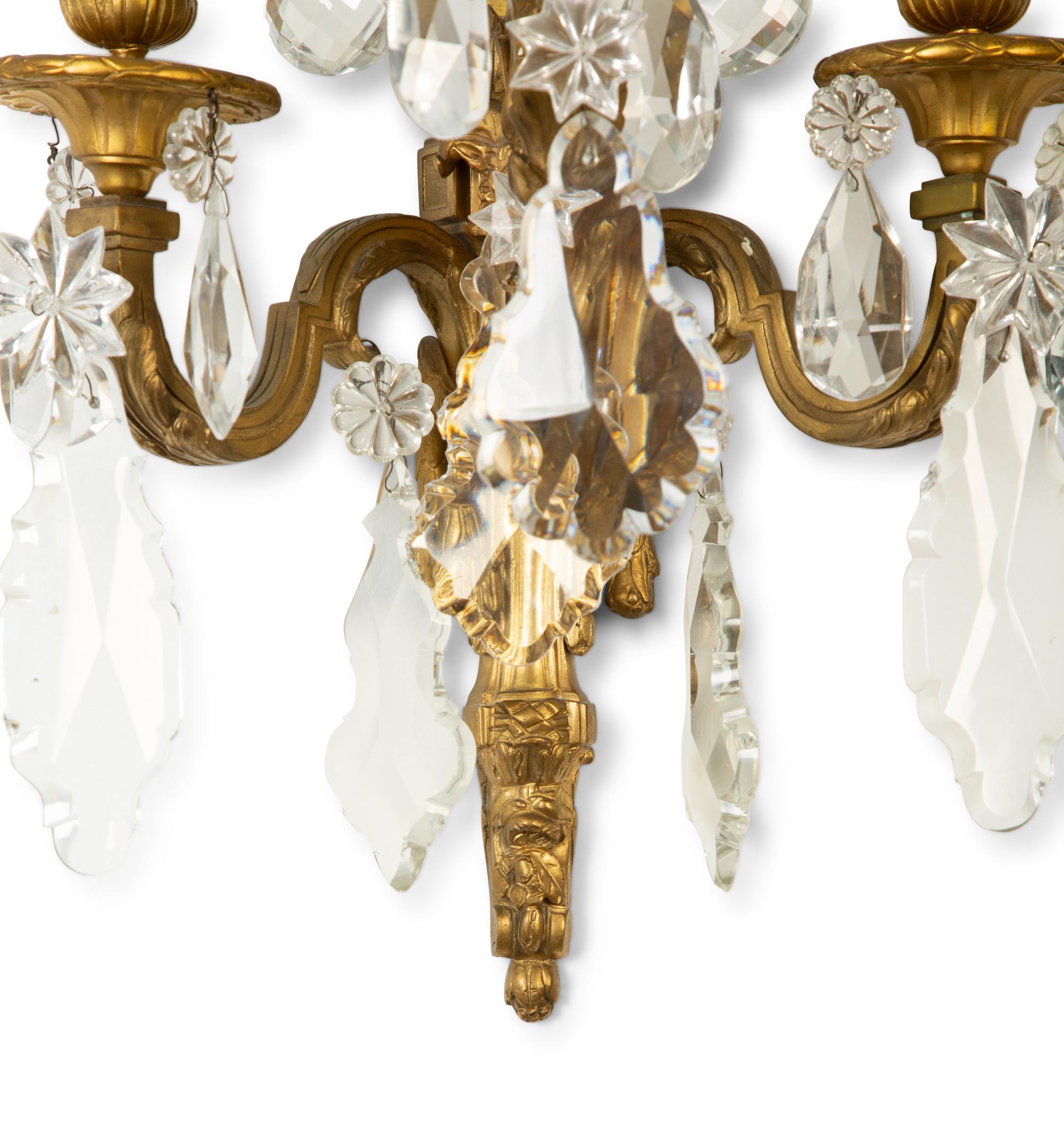 A Pair of Louis XVI Style Gilt Bronze and Cut Glass Three-Light Sconces