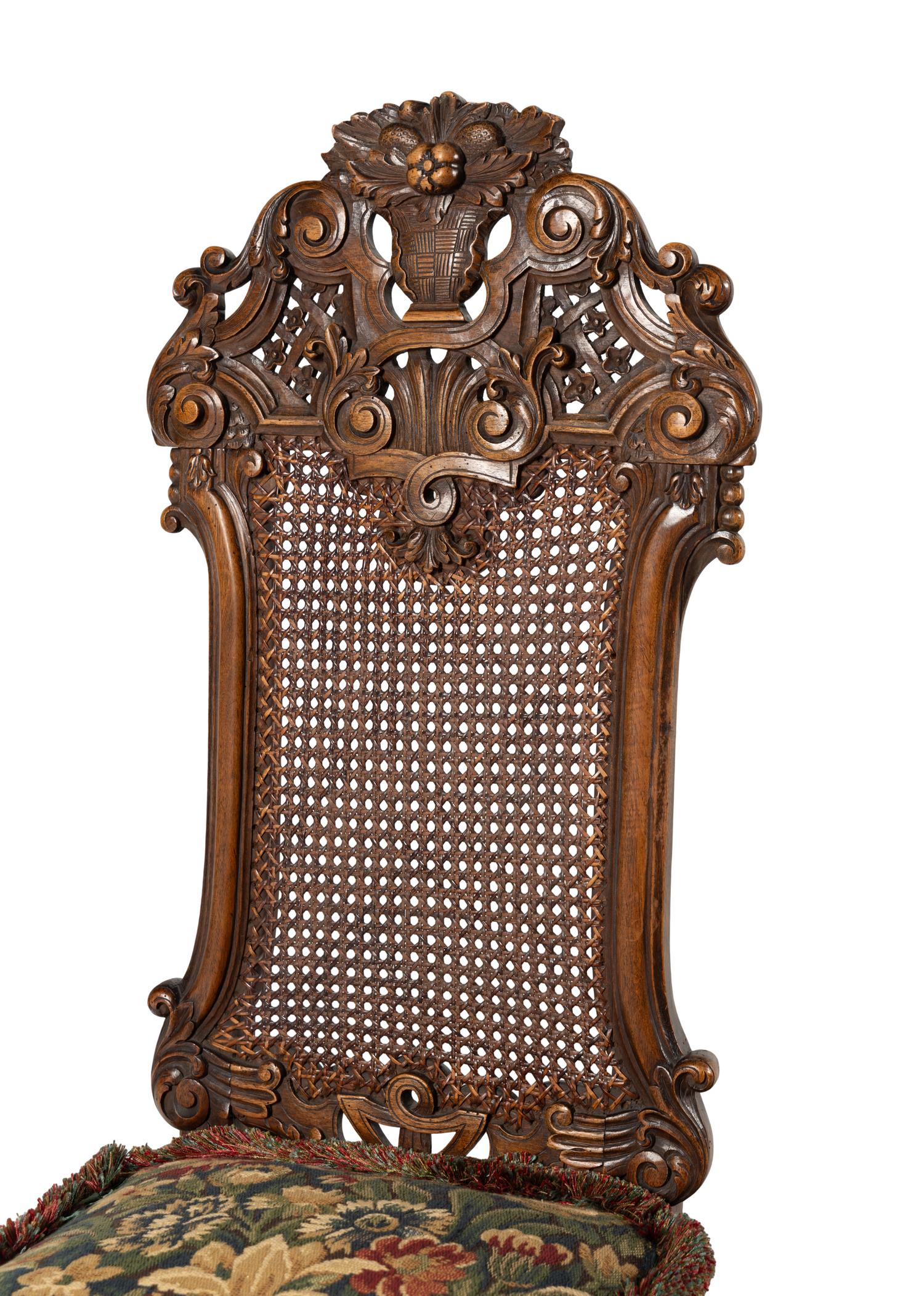 A Set of Four William and Mary Style Caned and Pierced-Carved Walnut Dining Chairs
