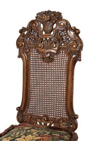 A Set of Four William and Mary Style Caned and Pierced-Carved Walnut Dining Chairs