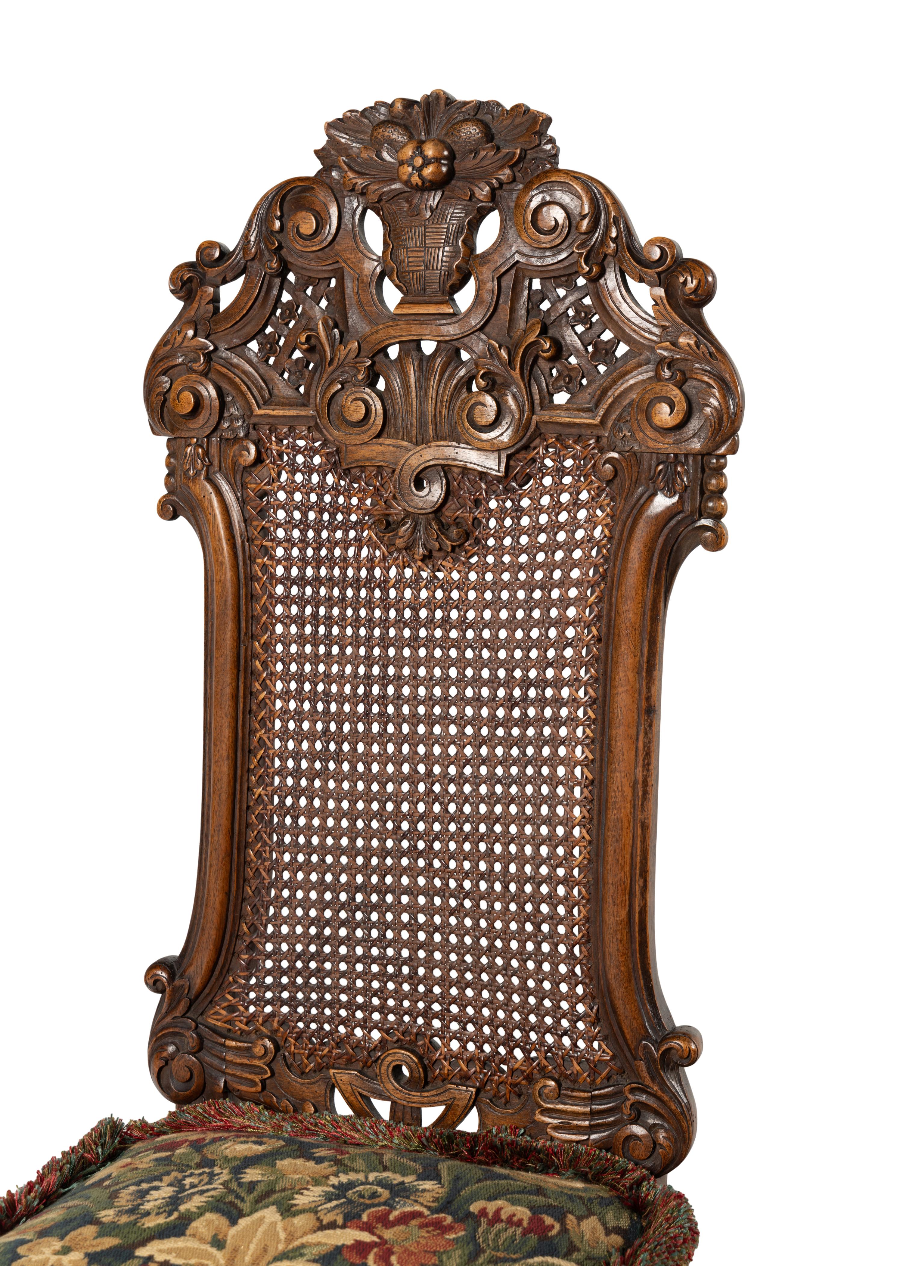 A Set of Four William and Mary Style Caned and Pierced-Carved Walnut Dining Chairs