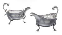 A Pair of George III Silver Sauce Boats, Hester Bateman, London, 1789, each having a foliate scroll handle and a beaded edge, raised on