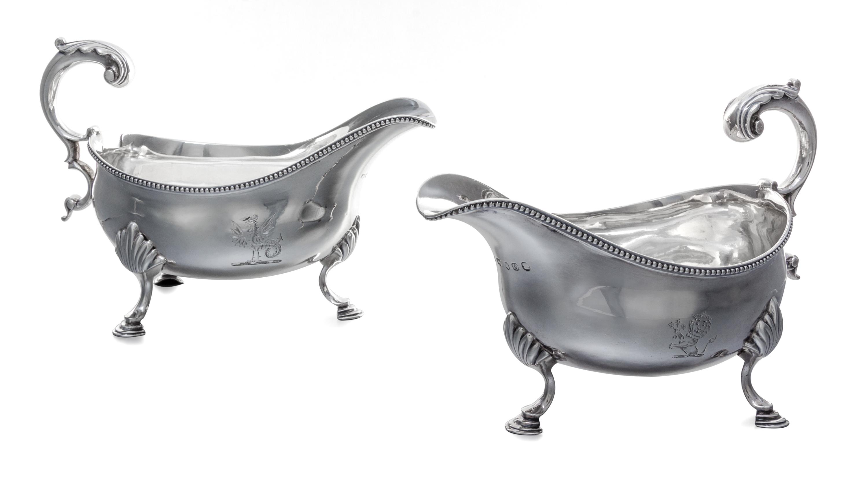 A Pair of George III Silver Sauce Boats, Hester Bateman, London, 1789, each having a foliate scroll handle and a beaded edge, raised on