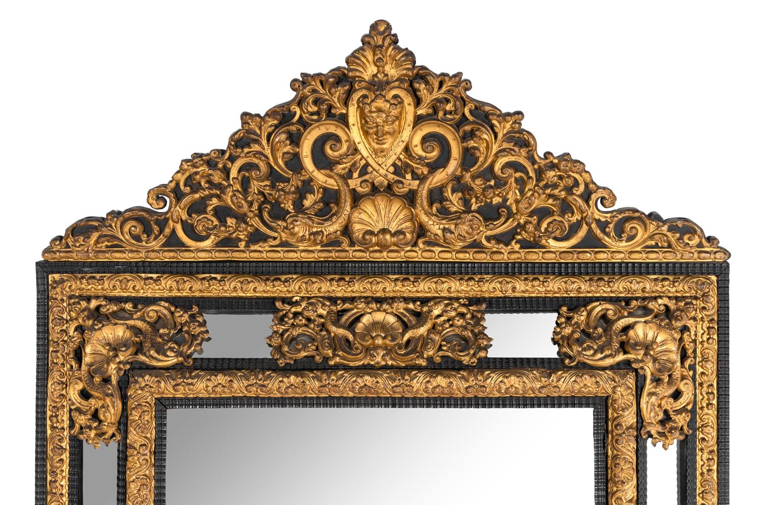 A Régence Style Gilt Pressed Metal and Ebonized Ripple-Molded Mirror