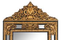 A Régence Style Gilt Pressed Metal and Ebonized Ripple-Molded Mirror