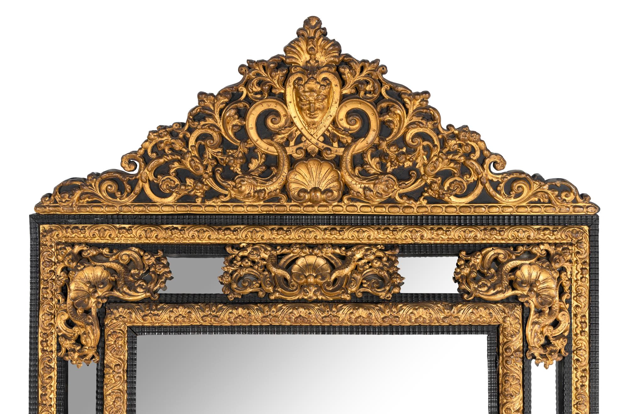 A Régence Style Gilt Pressed Metal and Ebonized Ripple-Molded Mirror
