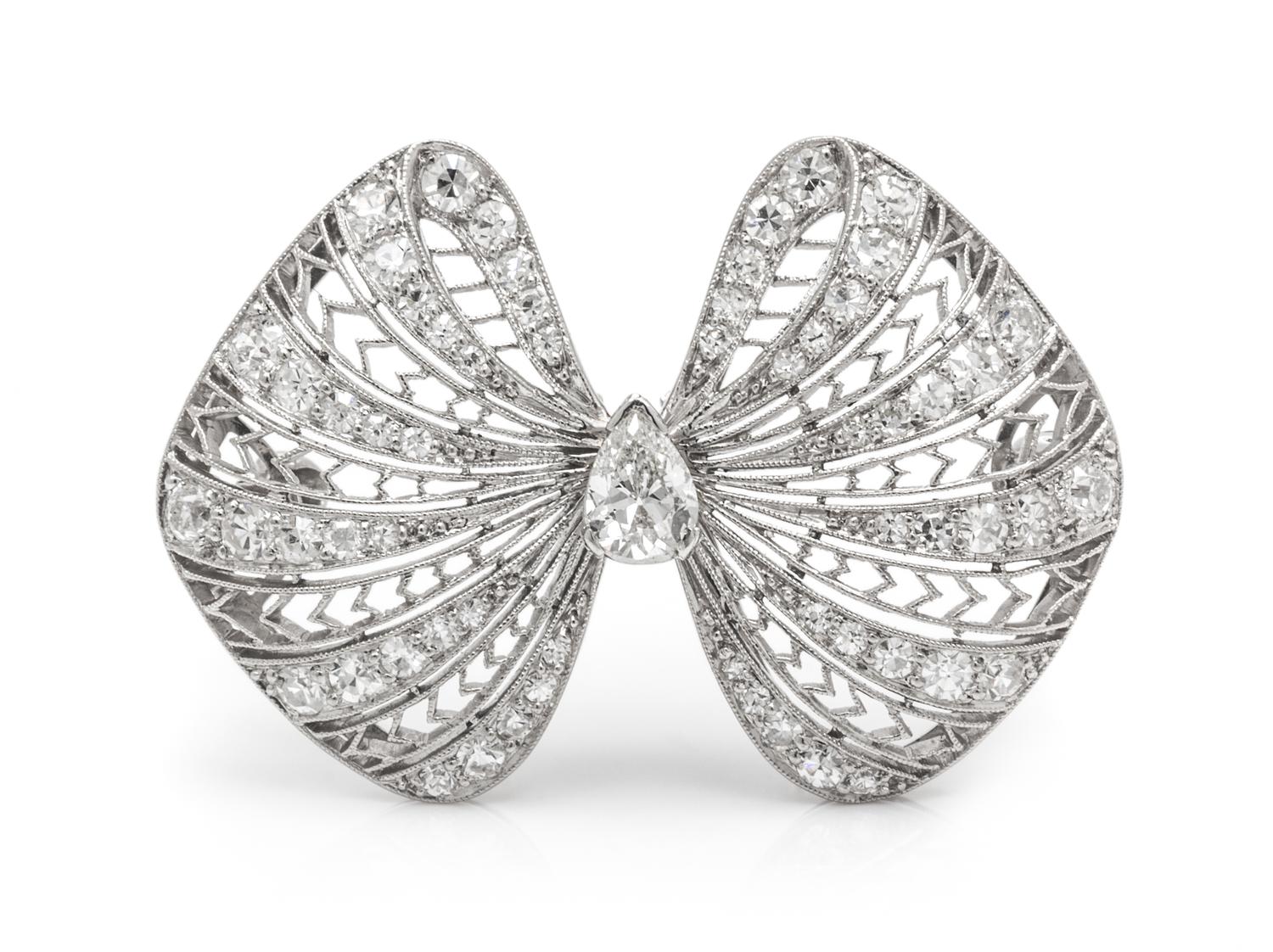 An Art Deco Platinum and Diamond Bow Motif Brooch, 5.90 dwts.
