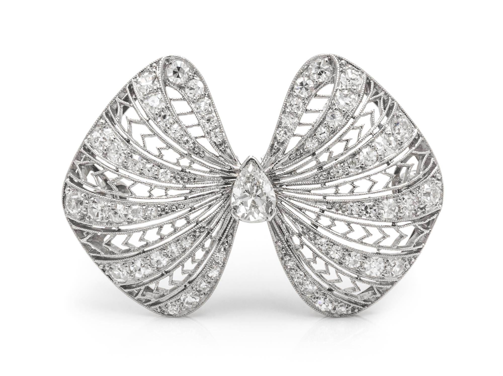 An Art Deco Platinum and Diamond Bow Motif Brooch, 5.90 dwts.
