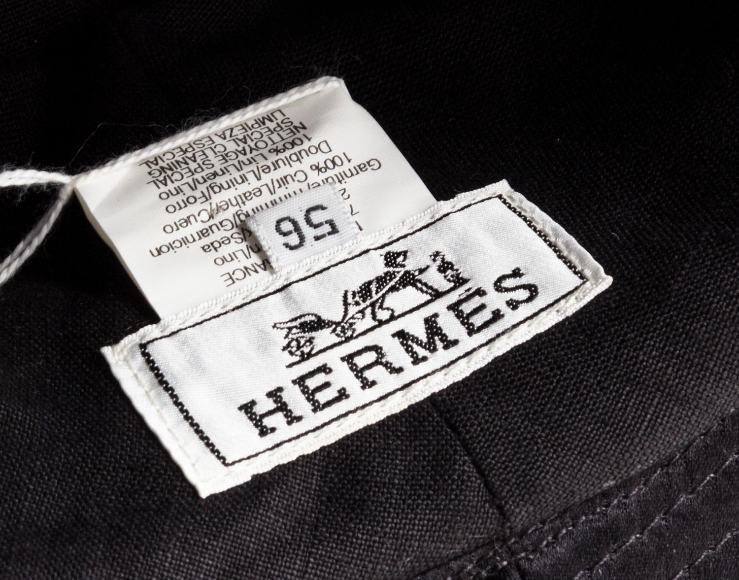 An Hermes Black Fabric and Metallic Leather Hat, Size 56.