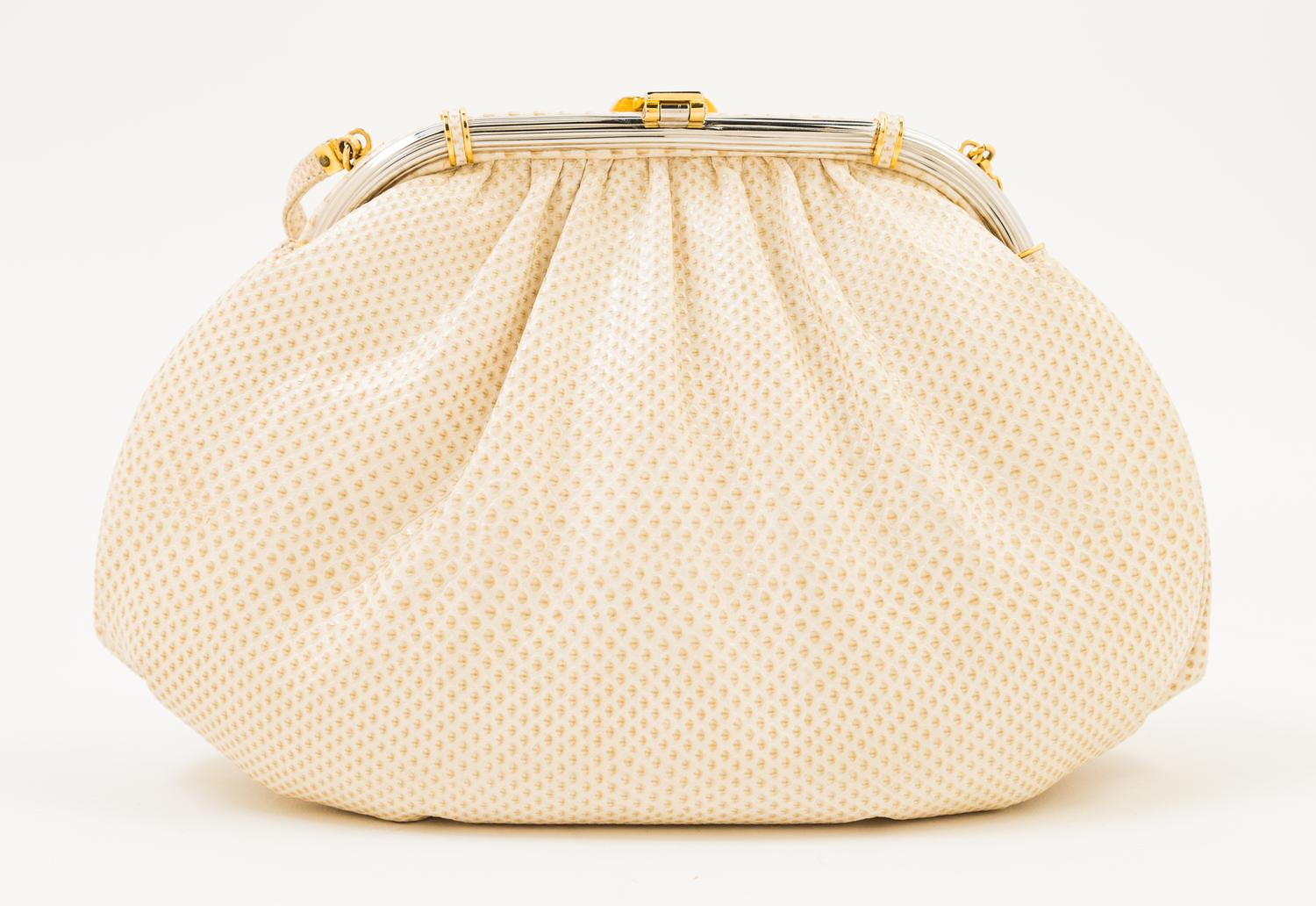 A Judith Leiber Ivory Snakeskin Clutch, 9.5" x 6" x 1.5".
