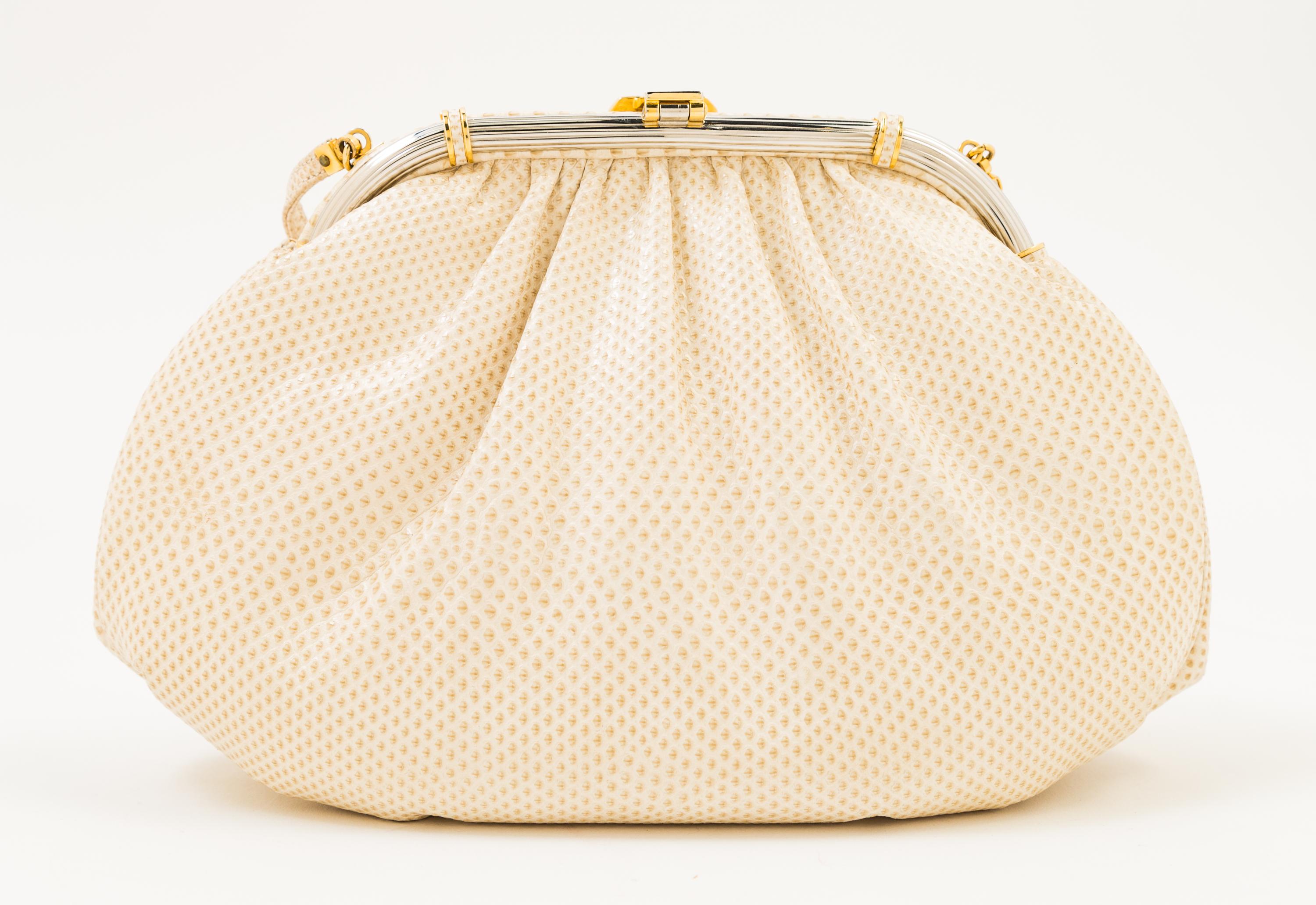 A Judith Leiber Ivory Snakeskin Clutch, 9.5" x 6" x 1.5".