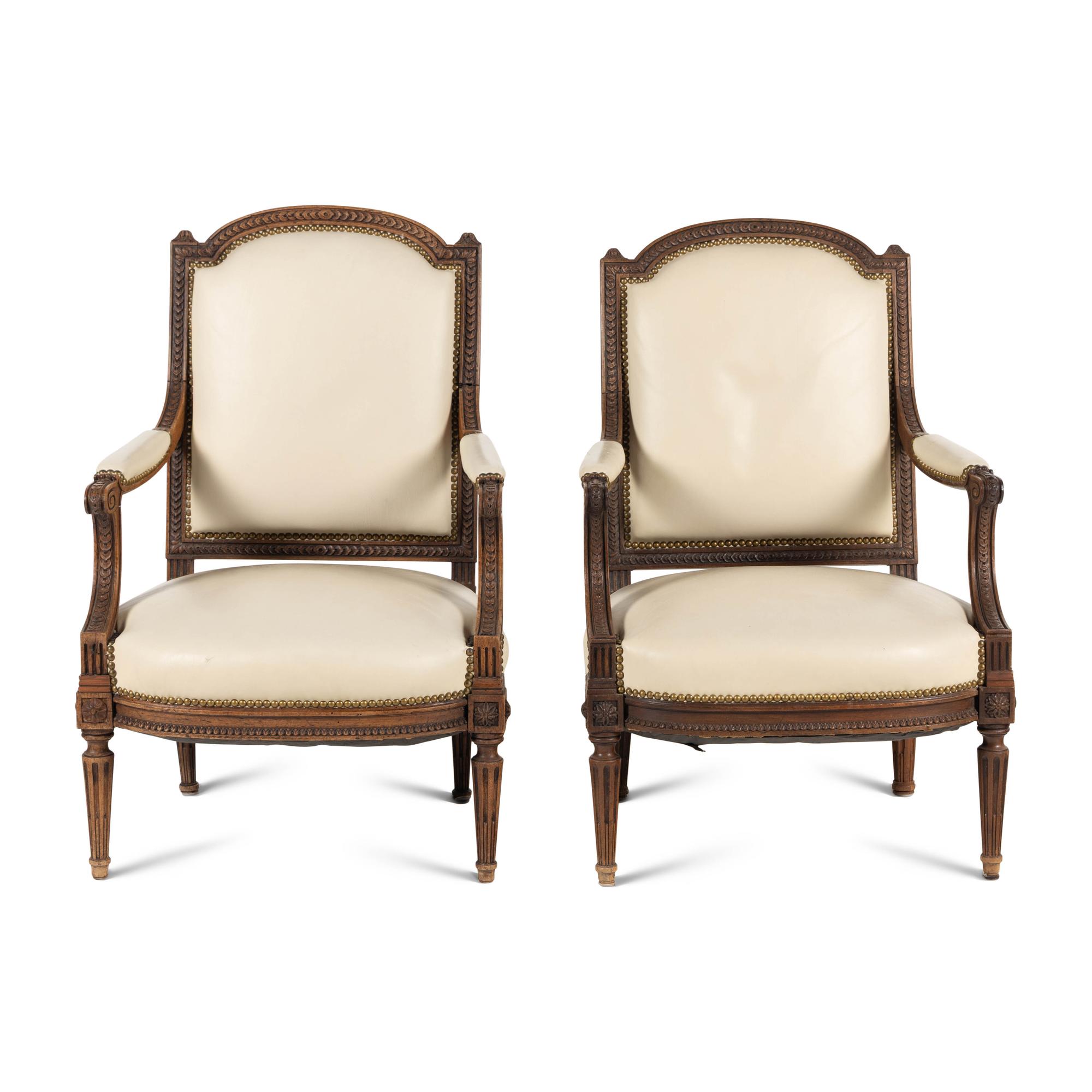 A Pair of Louis XVI Style Walnut Fauteuils