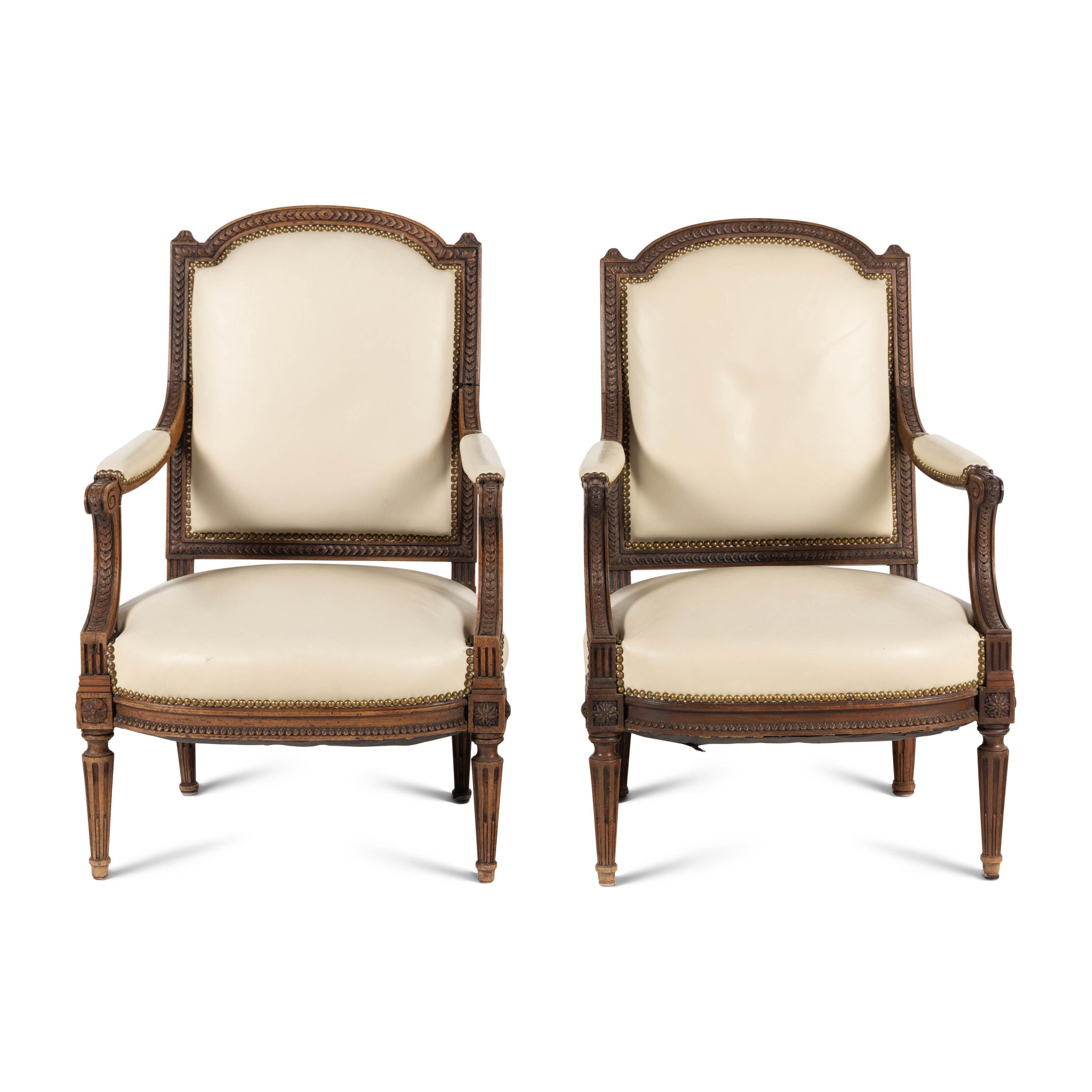 A Pair of Louis XVI Style Walnut Fauteuils