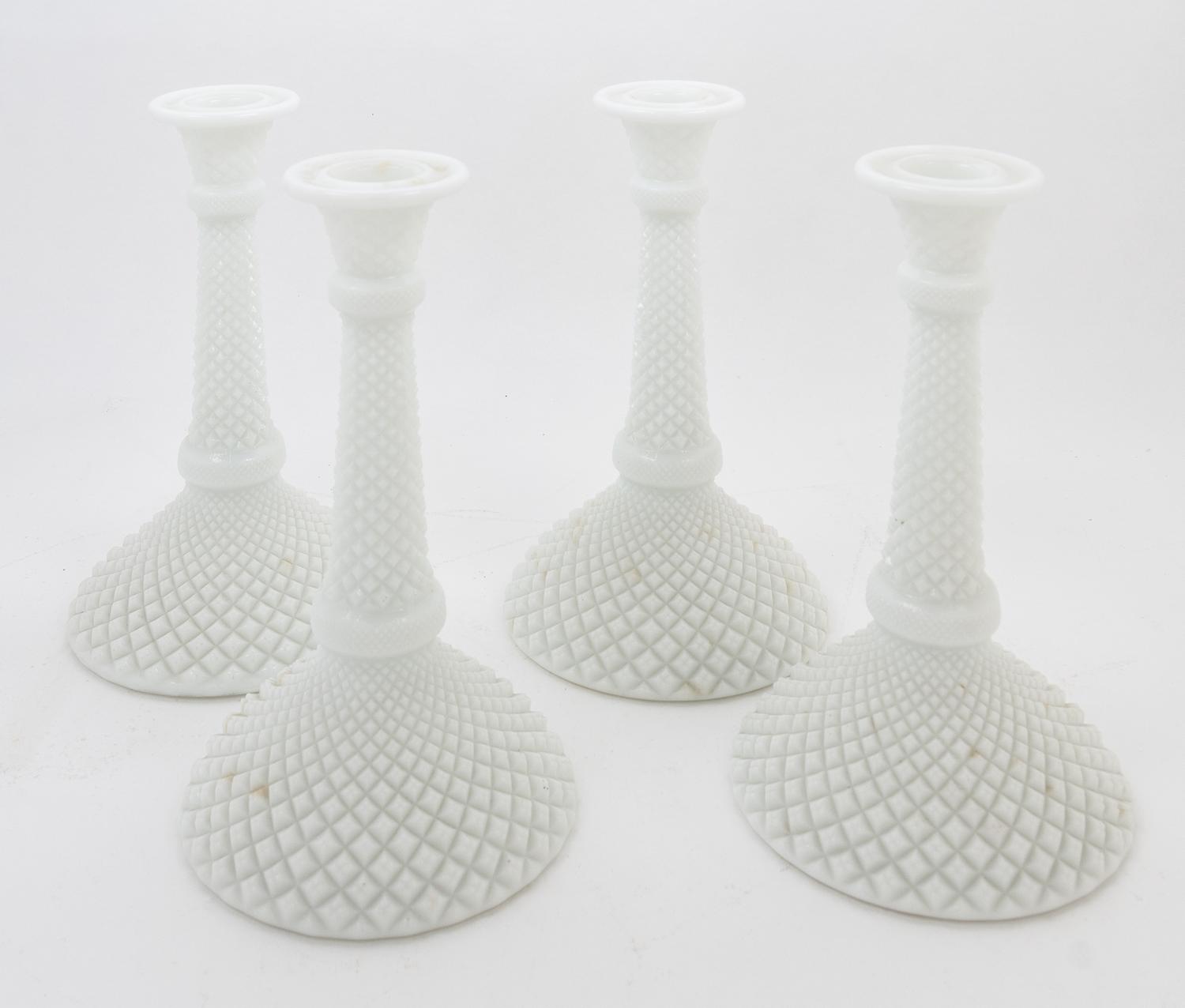 A Set of Four Milk Glass Candlesticks Height 8 inches.