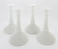 A Set of Four Milk Glass Candlesticks Height 8 inches.