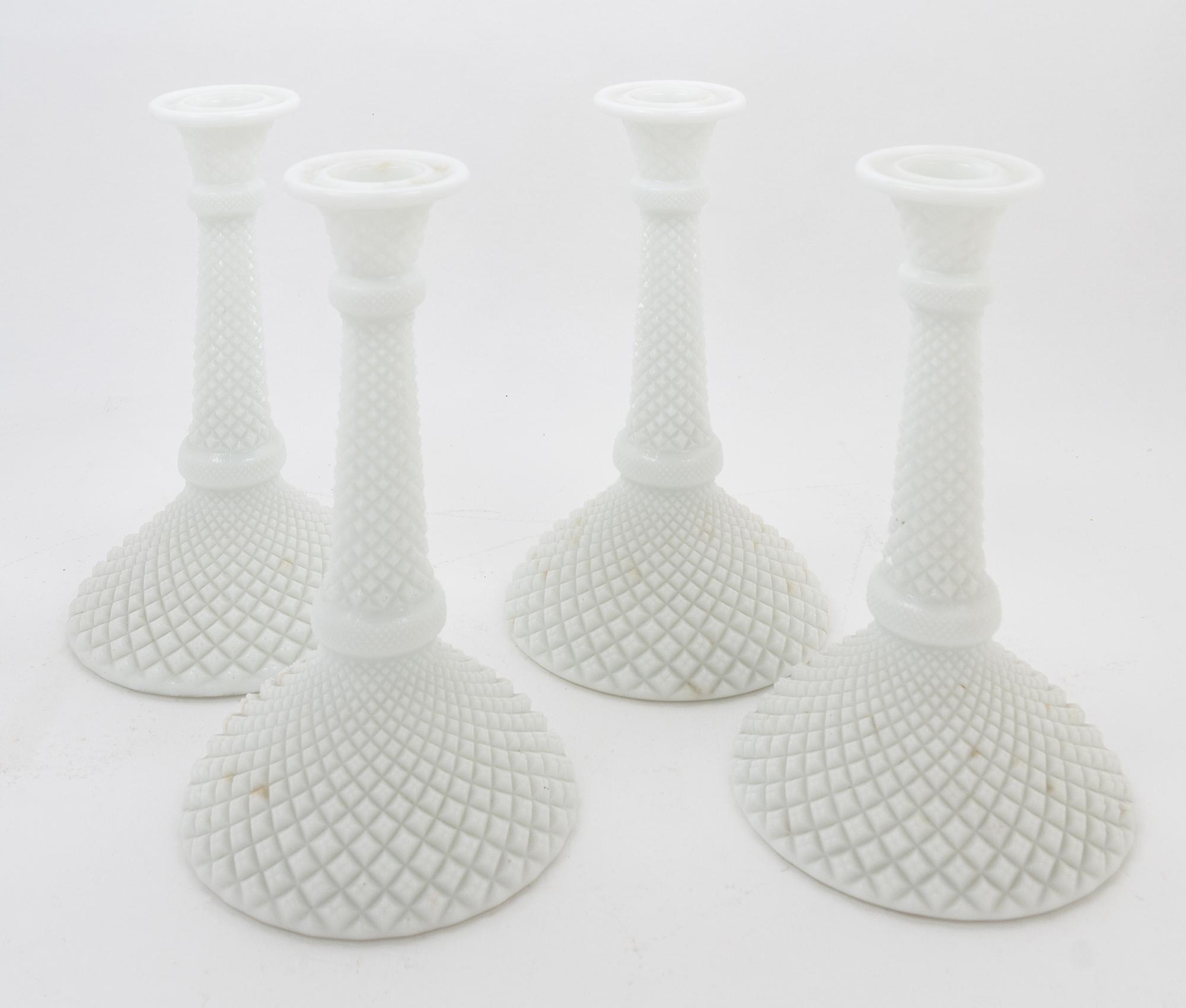 A Set of Four Milk Glass Candlesticks Height 8 inches.