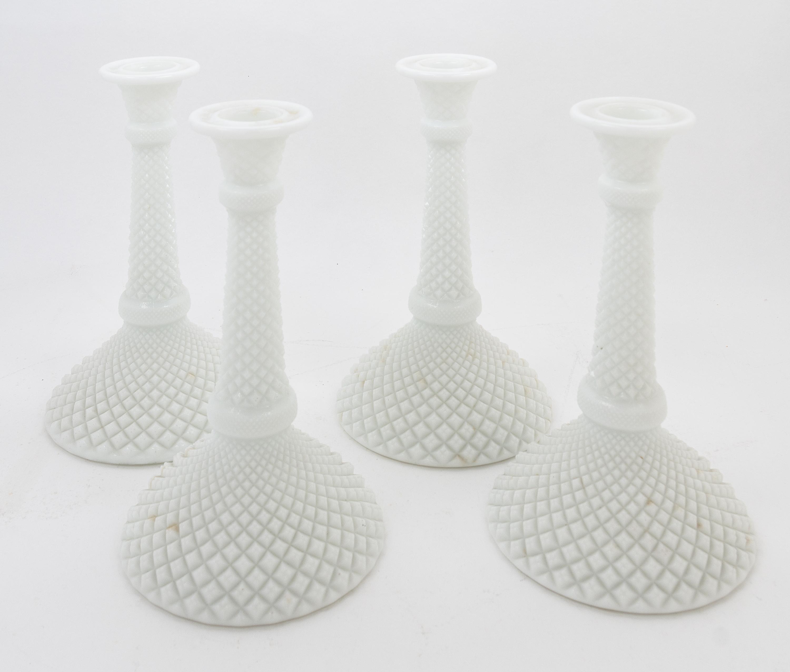 A Set of Four Milk Glass Candlesticks Height 8 inches.