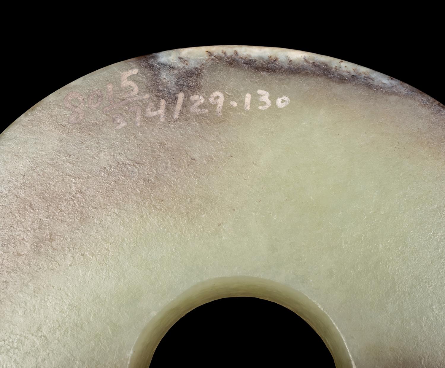 A Russet and Celadon Jade Bi Disc