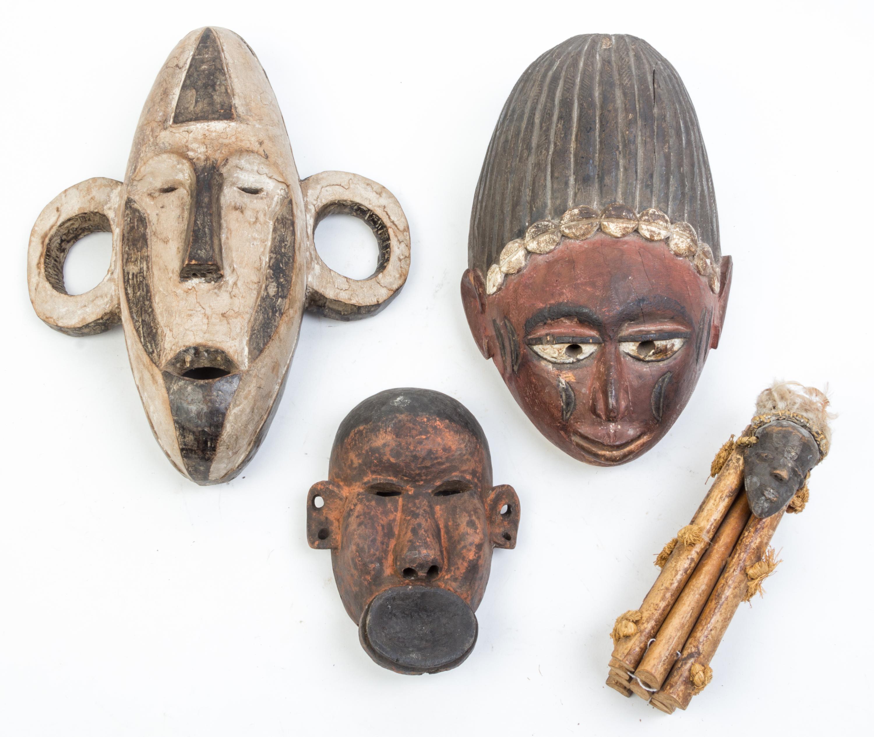 A Group of Four Masks Height of largest 23 inches.