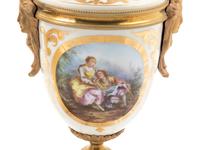 A Pair of Sèvres Style Gilt Bronze Mounted Painted and Parcel Gilt Porcelain Urns