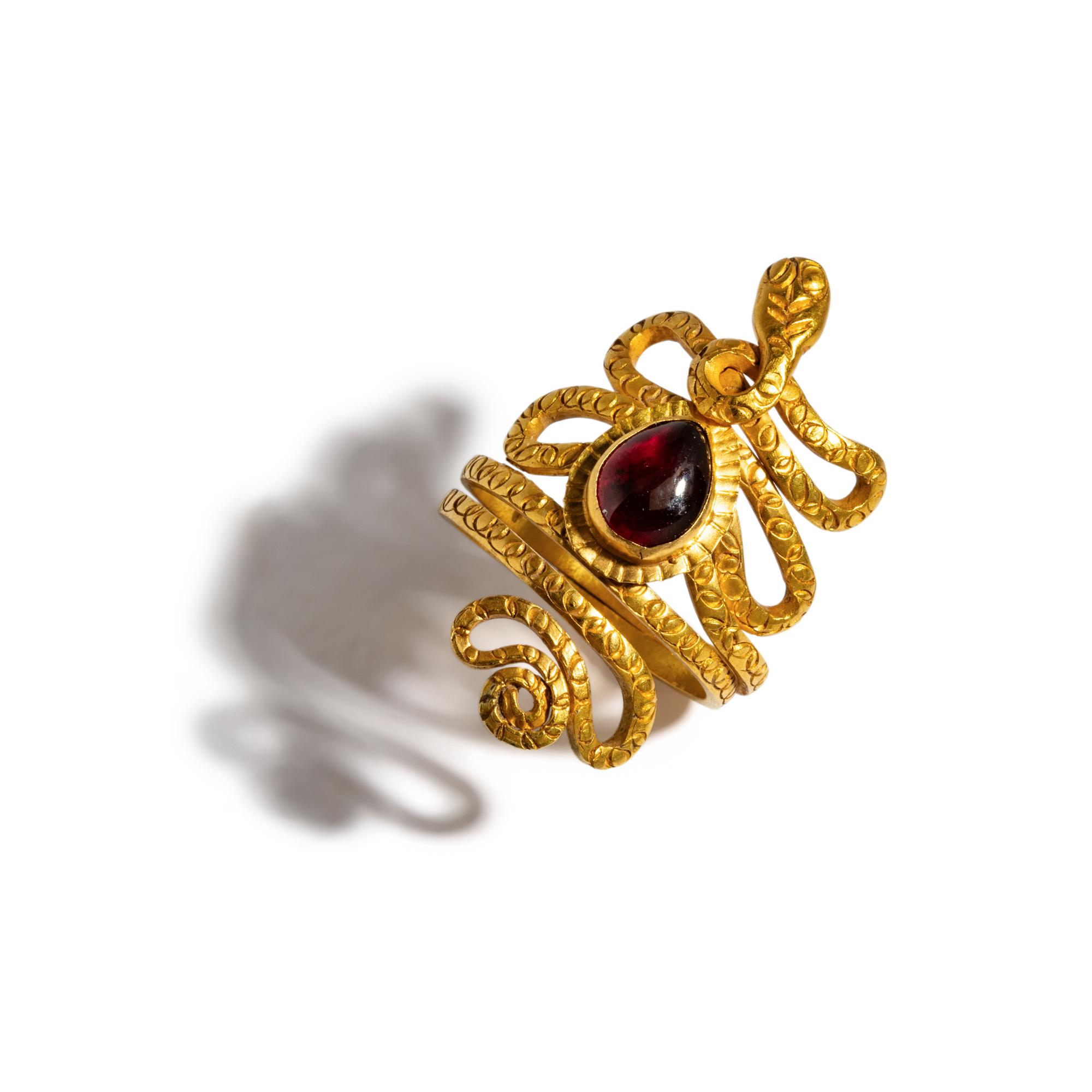 An Egyptian Gold and Garnet Snake Ring