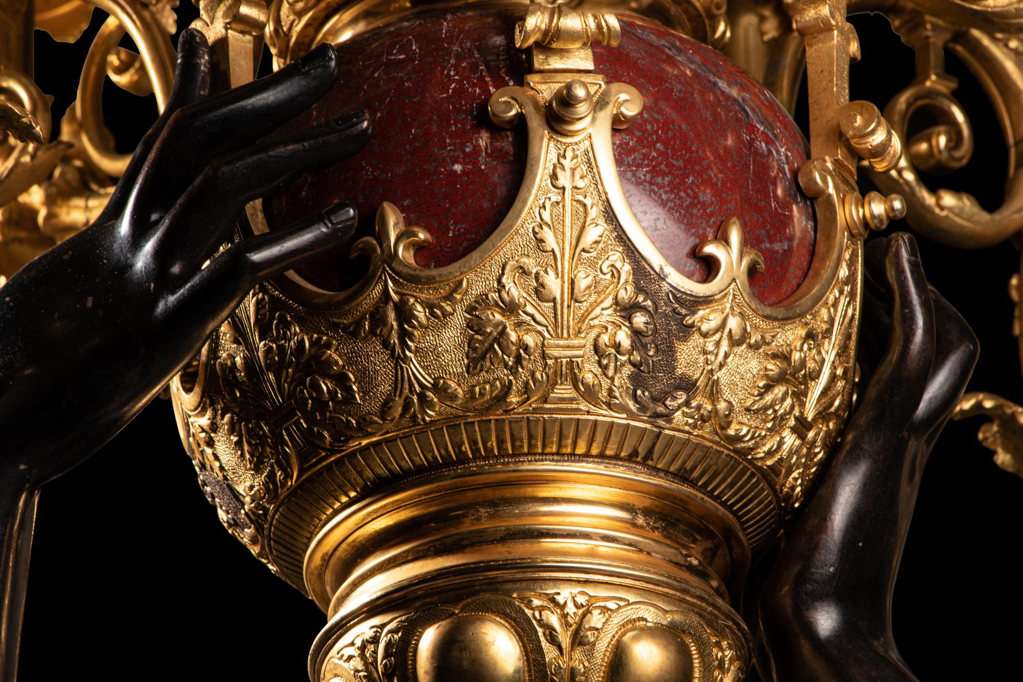 A Pair of Monumental Gilt and Patinated Bronze and Rouge Marble Figural Torchères