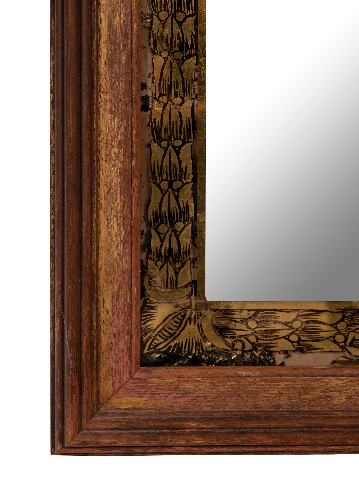 A Gothic Style Giltwood and Églomisé Mirror