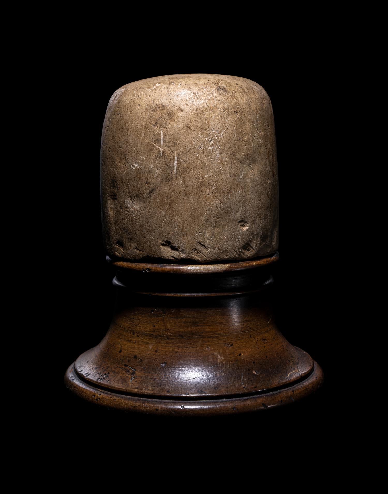 An Egyptian Limestone Canopic Jar Lid in the Form of Qebhsenuef