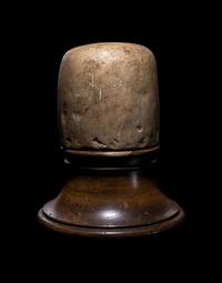 An Egyptian Limestone Canopic Jar Lid in the Form of Qebhsenuef